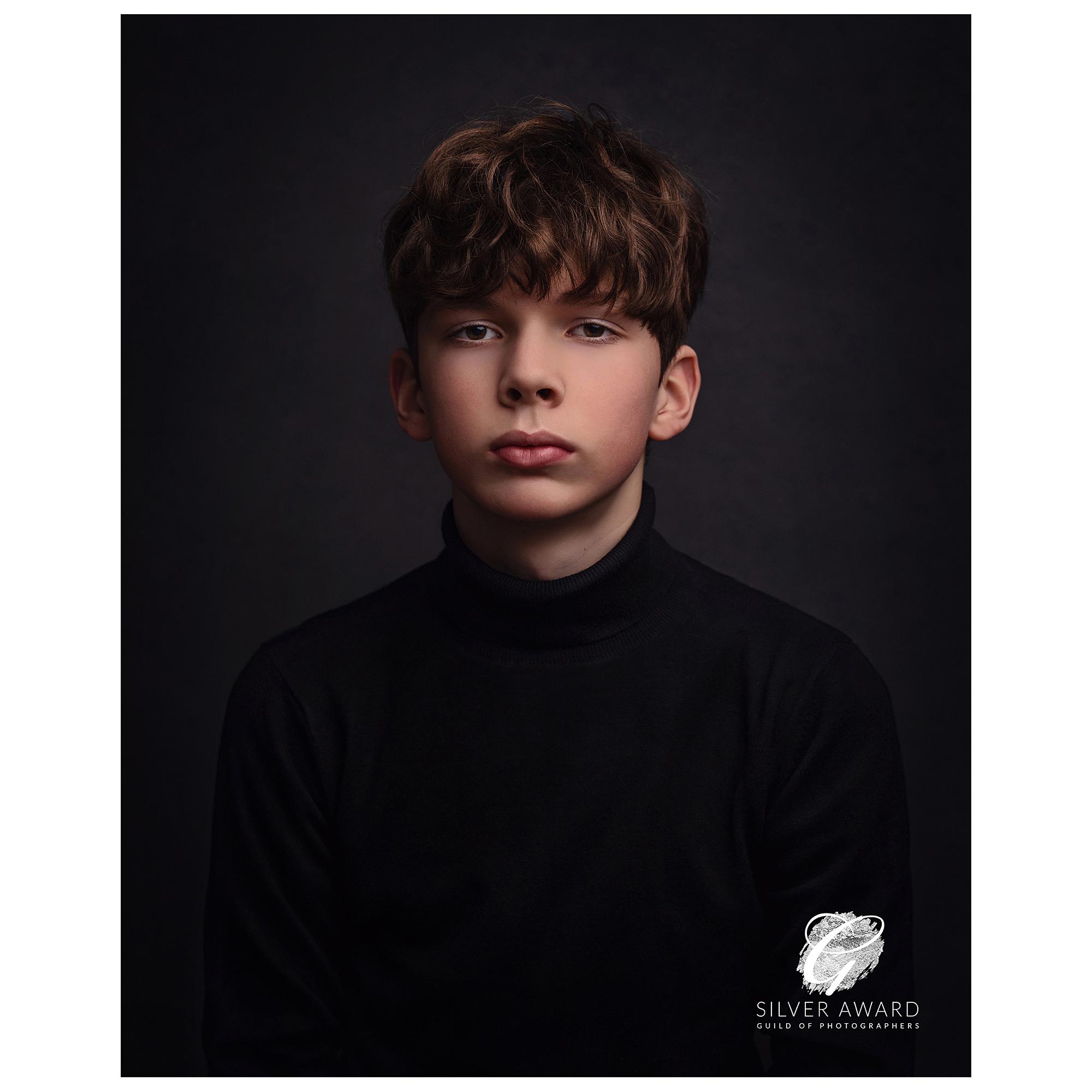 Fine Art Portrait of a Teenage Boy in a black polo neck jumper wins a Silver Award from the Guild of Photographers