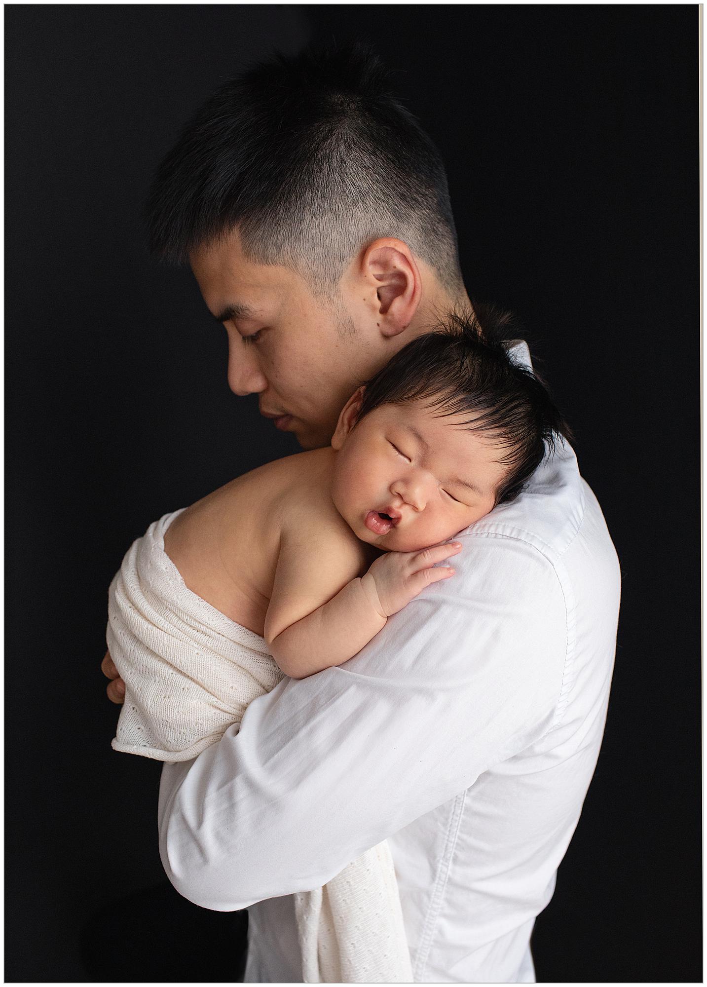 Baby Girl sleeps on her Dad's shoulder