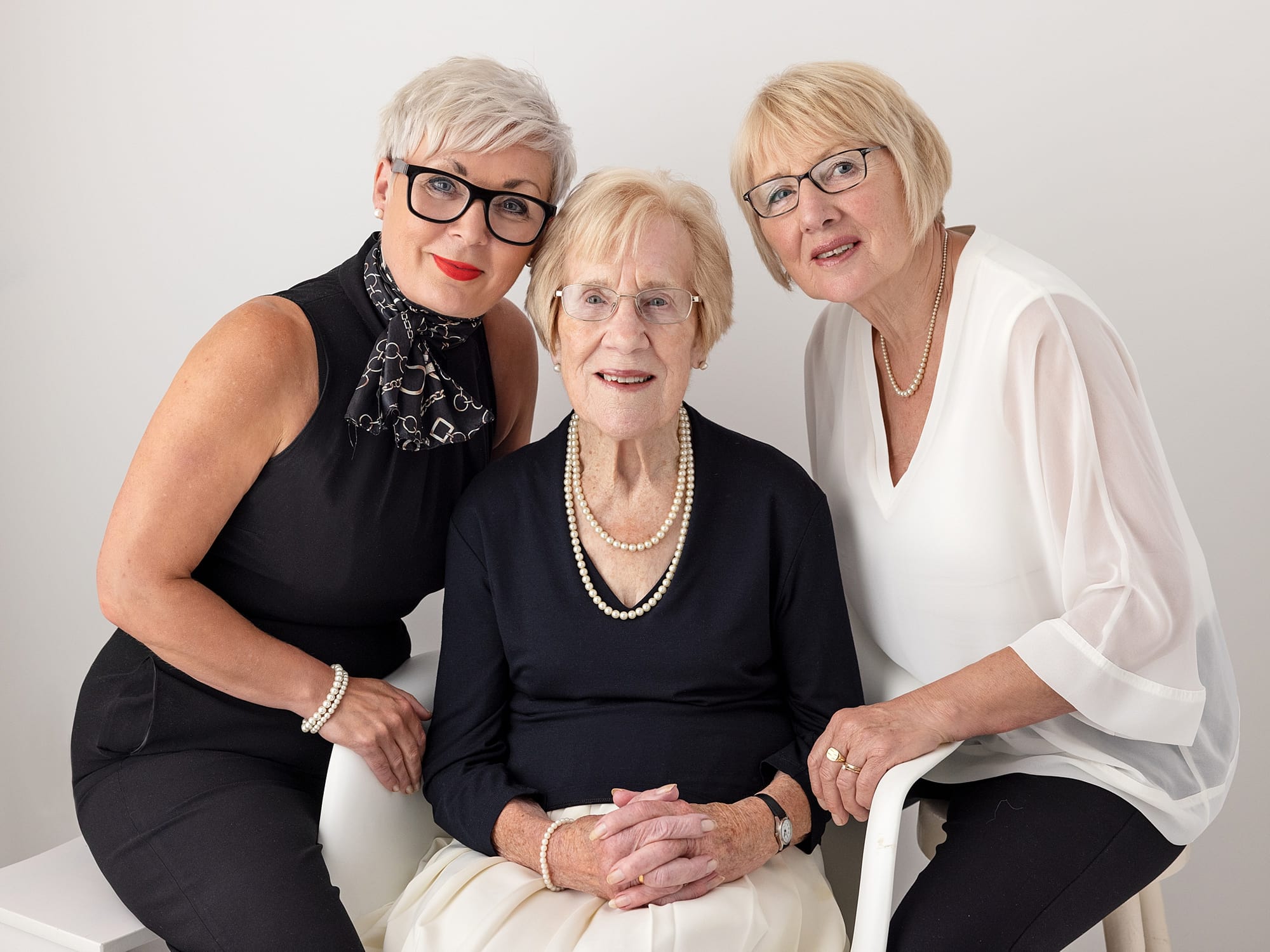Three generations of women in one family pose for an extended family photoshoot in Suffolk Studio