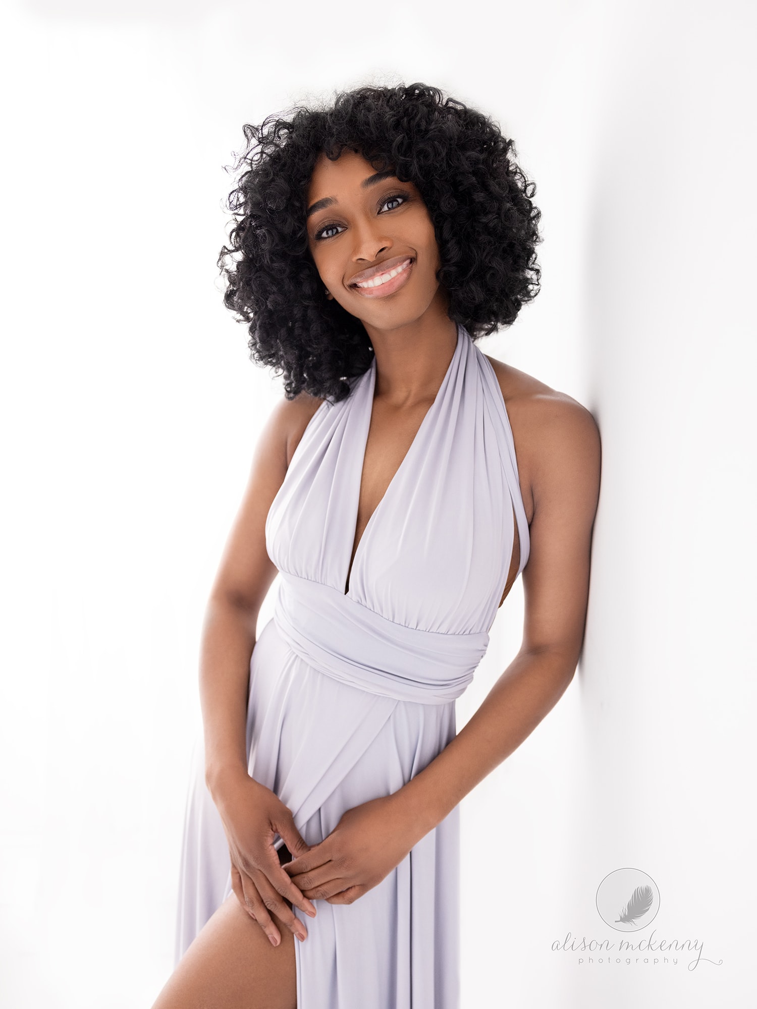 Beautiful woman in a grey dress smiles during her Beauty Shoot