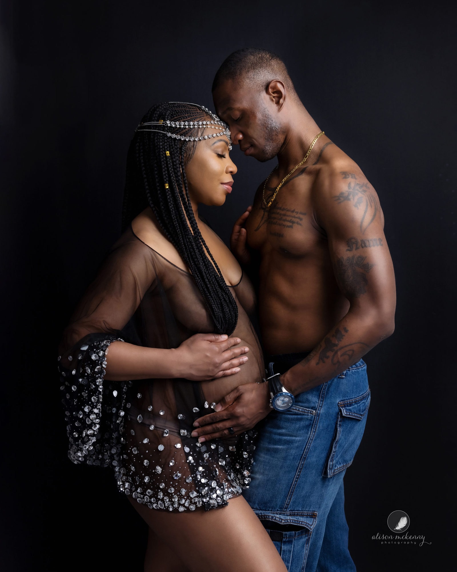 Pregnant lady with her partner posing for Maternity Photoshoot in Suffolk studio