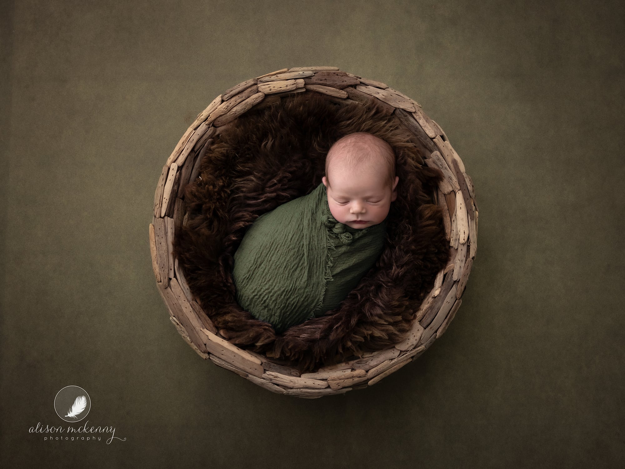 Newborn Baby Photographer Haverhill photographs baby boy in rustic wood bowl