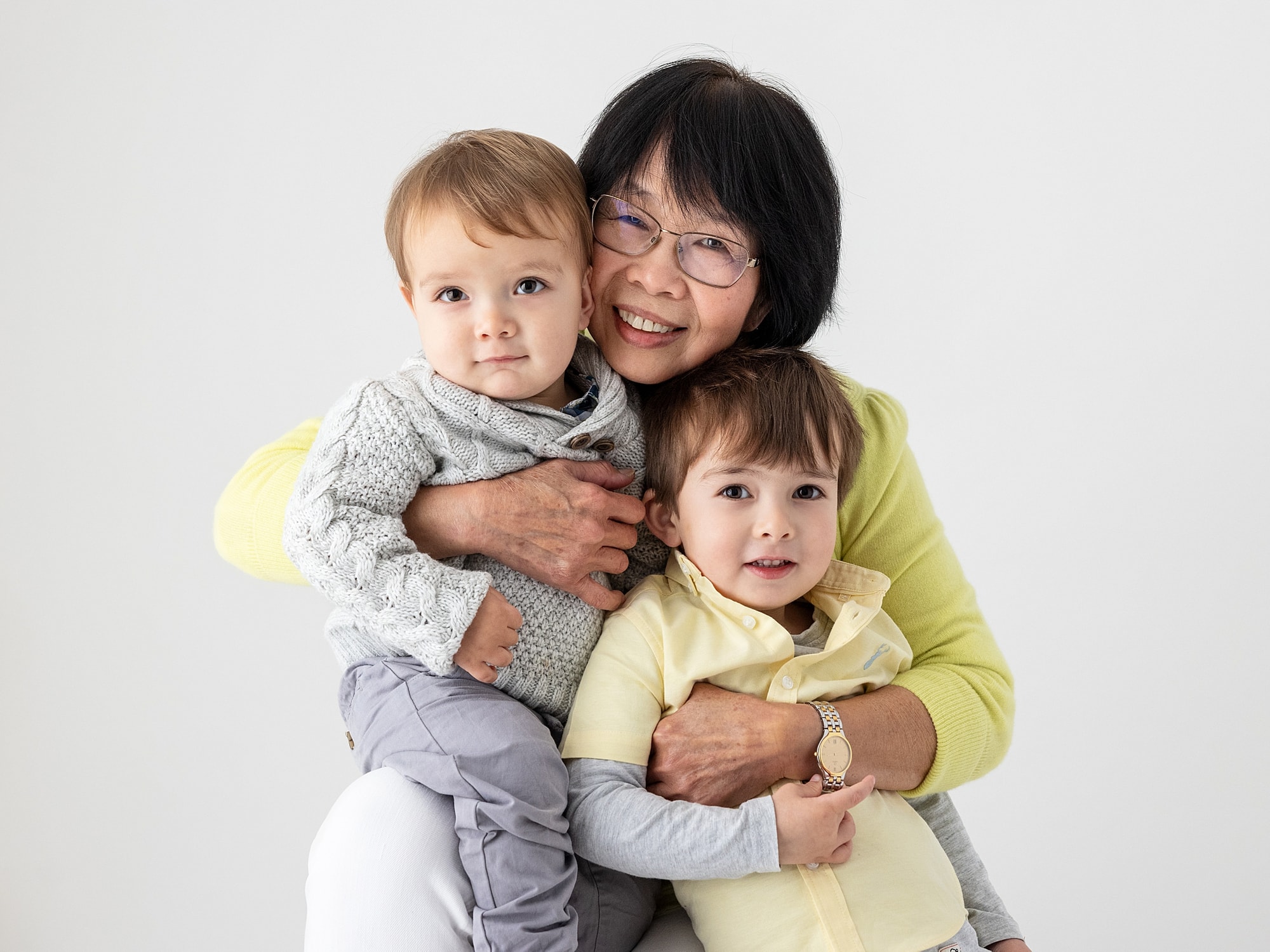 Granny cuddling her grandkids during family photoshoot