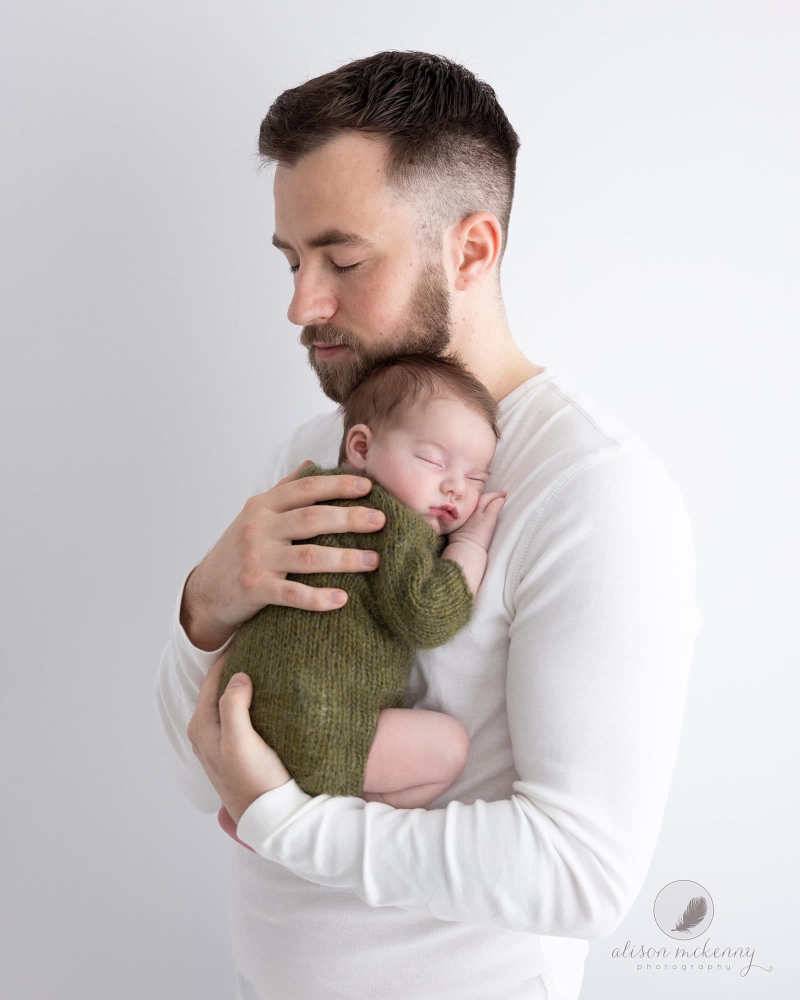 Father holds Newborn Baby Girl during photoshoot with Suffolk Photographer