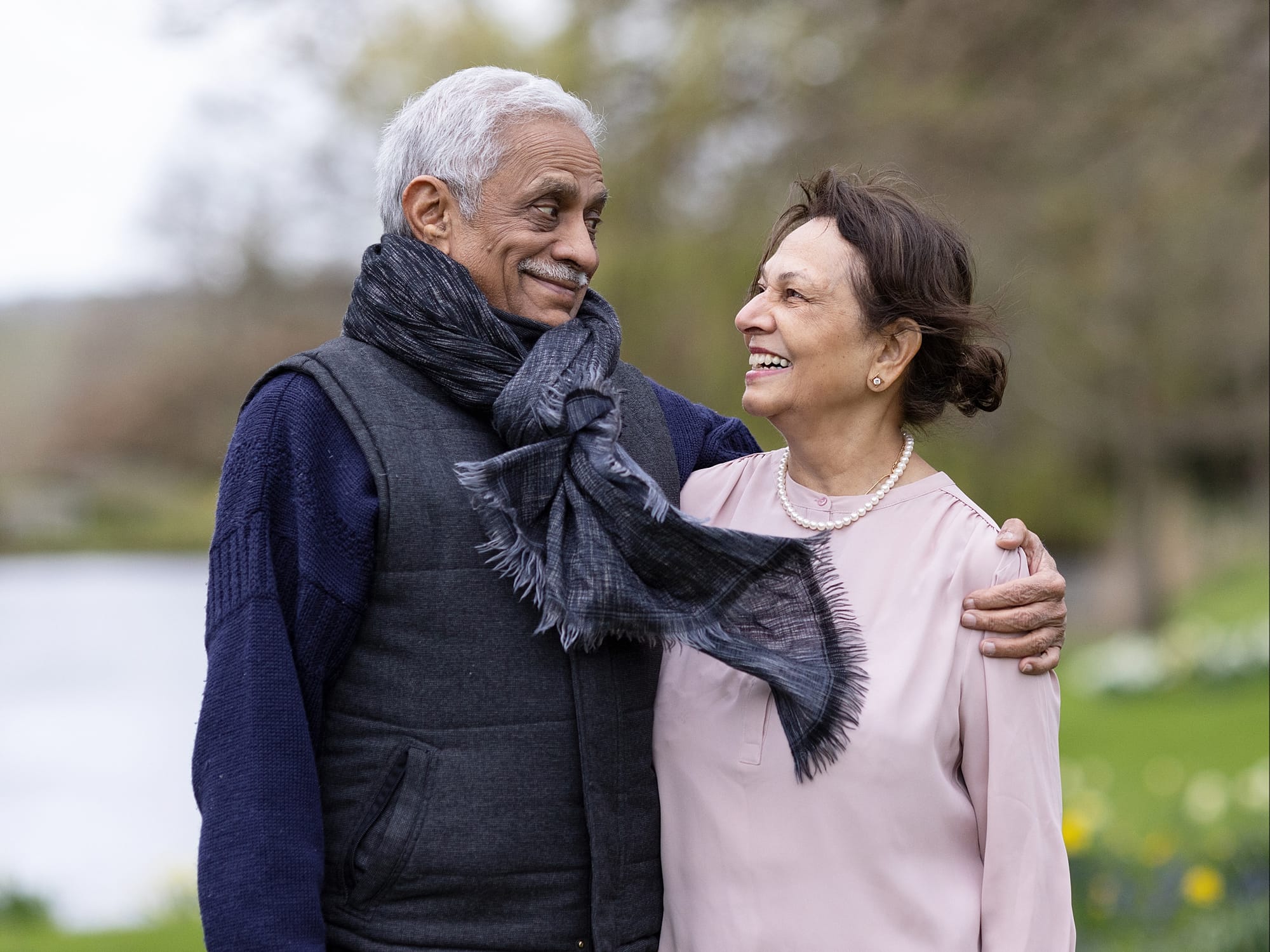 Older couple hug and smile at each other during a family photoshoot