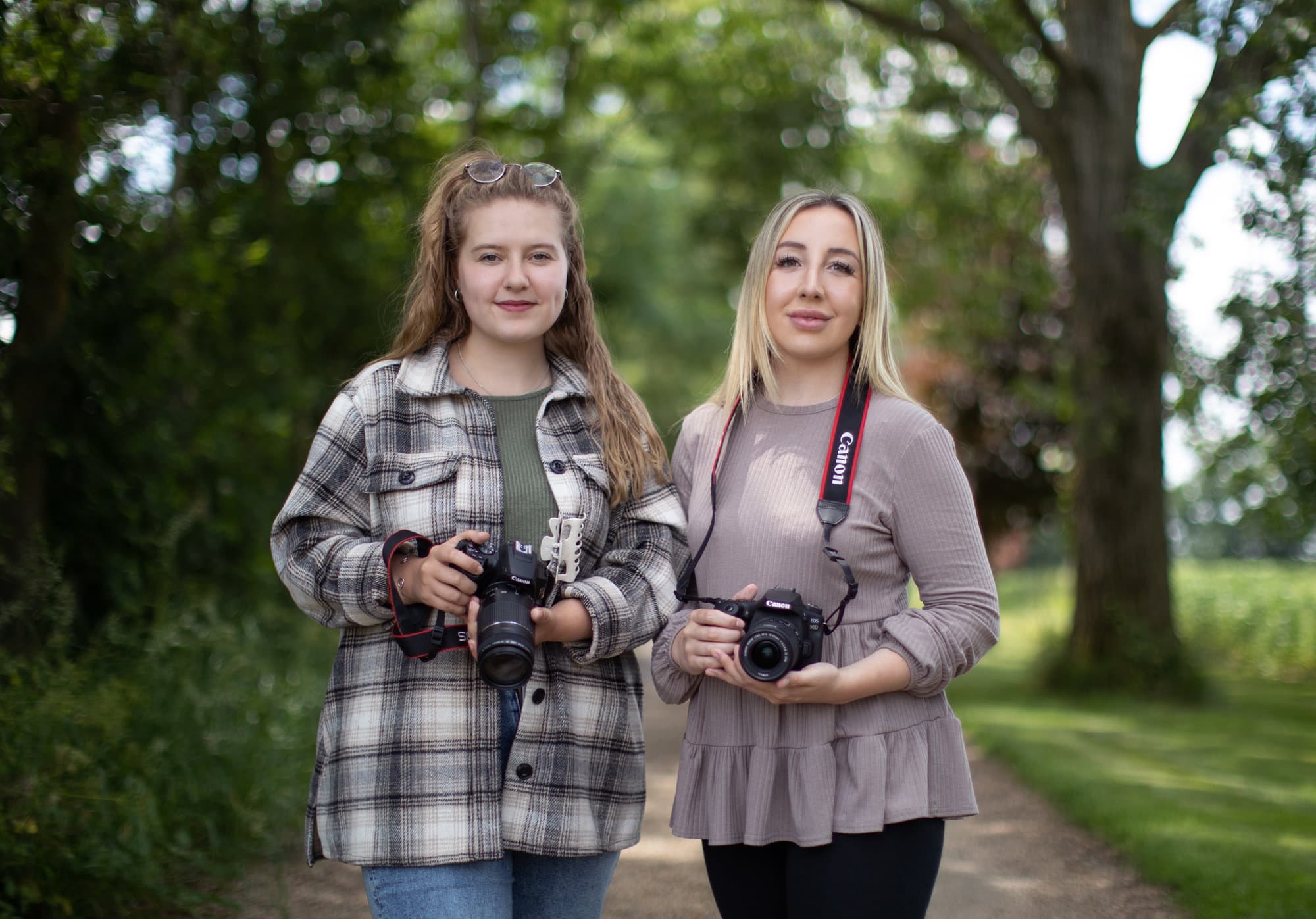 Two female Photographers pose for photo with their cameras during Beginners Photography Workshop with Alison McKenny