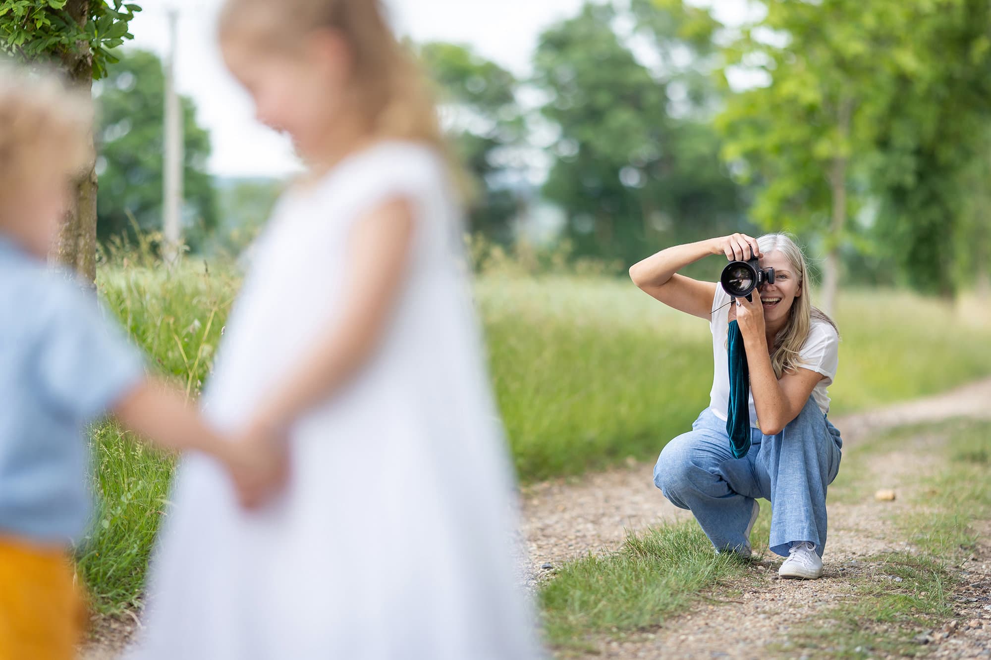 Alison Mckenny takes a photo of two small children during a Family Photoshoot on her farm in Suffolk