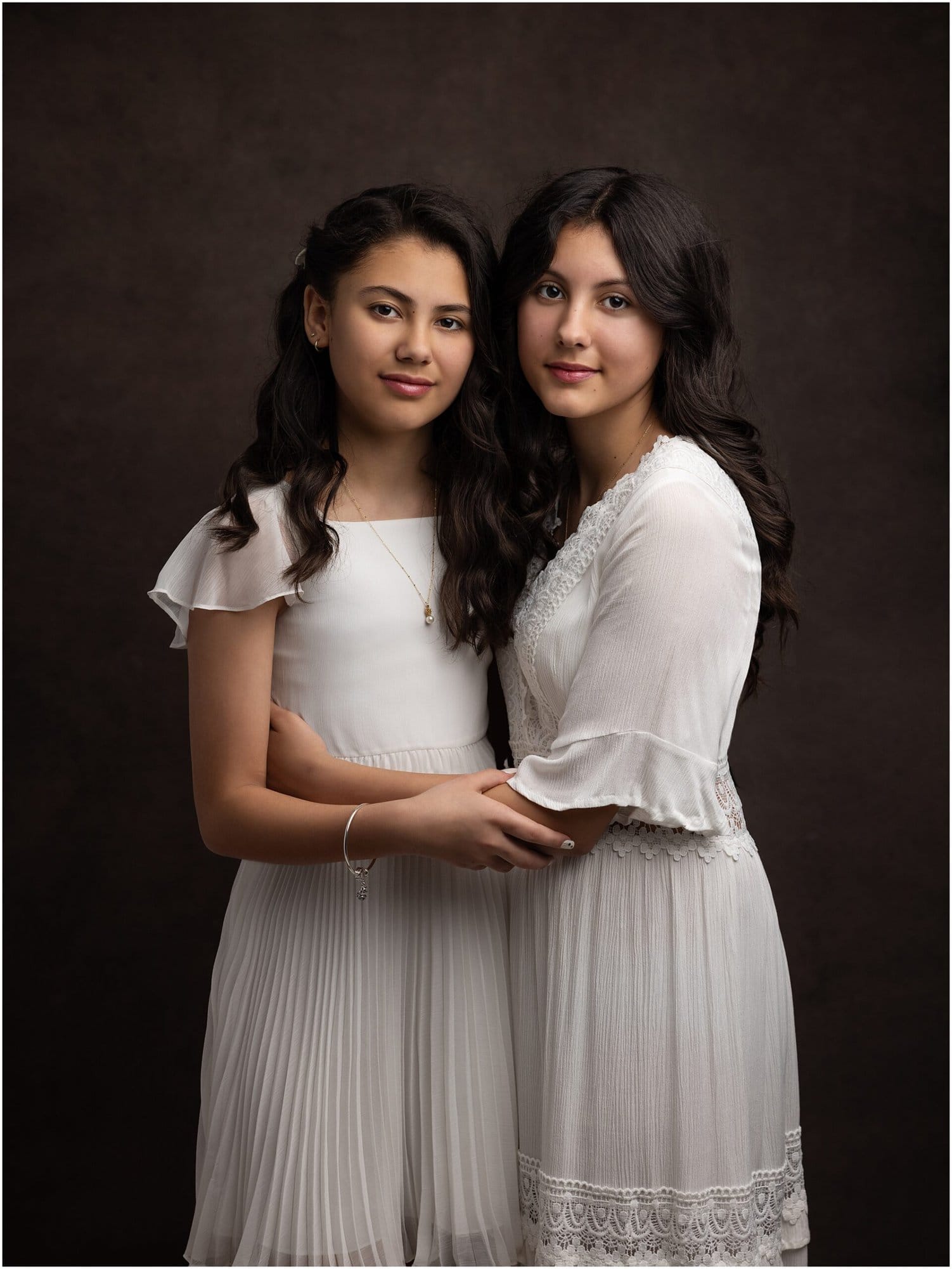 Two Sisters embrace during a Family Photoshoot at the studio of Alison McKenny, Suffolk Portrait Photographer