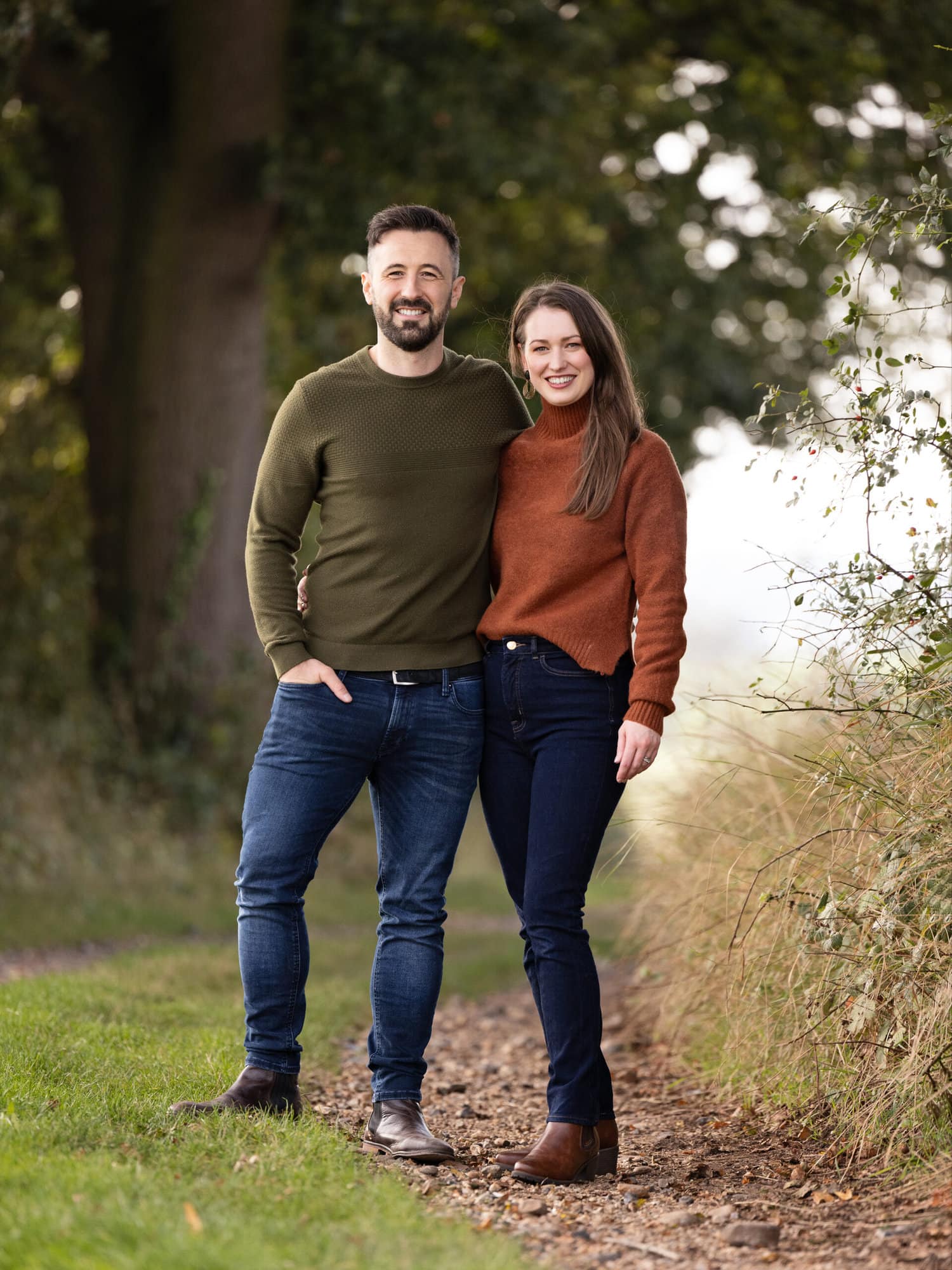 Man and Wife hug and smile during an Autumn Mini Shoot on Suffolk farm with Alison McKenny