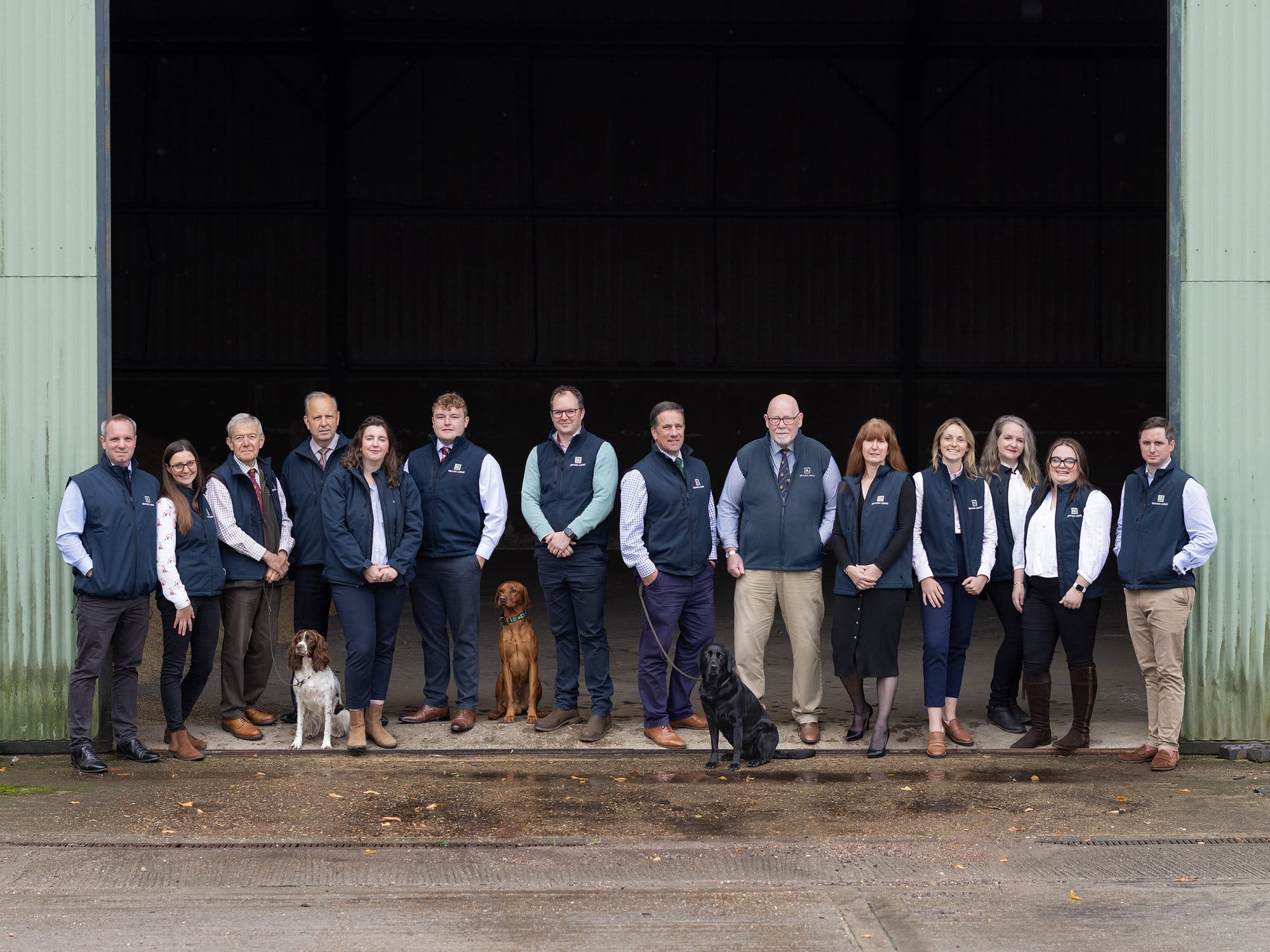 Brooks Leney Team pose in a barn doorway during a Commercial Photoshoot with Alison McKenny Photography
