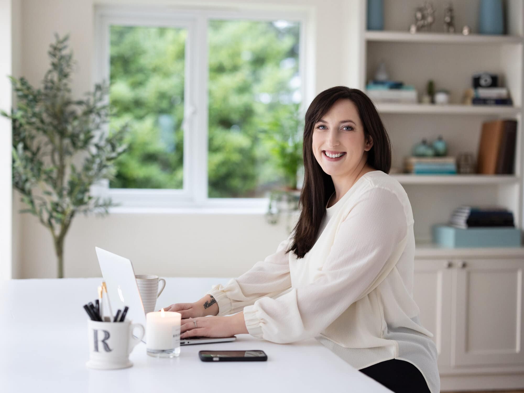 Personal Branding photo of a website and branding designer at her desk in her office